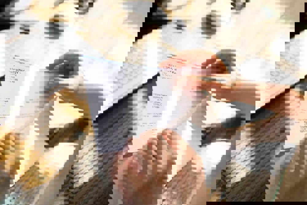 Person putting letter in envelope